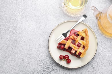 Photo of Piece of tasty cherry pie, berries and tea on grey textured table, flat lay. Space for text
