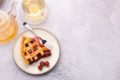 Photo of Piece of tasty cherry pie, berries and tea on grey textured table, flat lay. Space for text