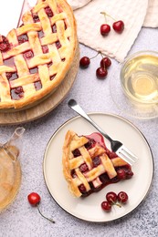 Photo of Tasty cherry pie, berries and tea on grey textured table, flat lay