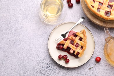 Photo of Tasty cherry pie, berries and tea on grey textured table, flat lay. Space for text