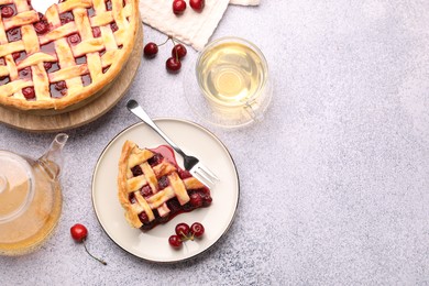 Photo of Tasty cherry pie, berries and tea on grey textured table, flat lay. Space for text