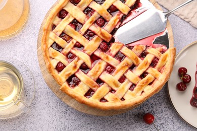 Photo of Tasty cherry pie, berries and tea on grey textured table, flat lay
