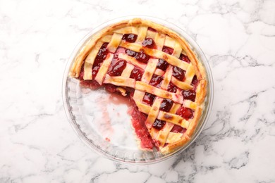 Photo of Tasty strawberry pie in baking dish on white marble table, top view