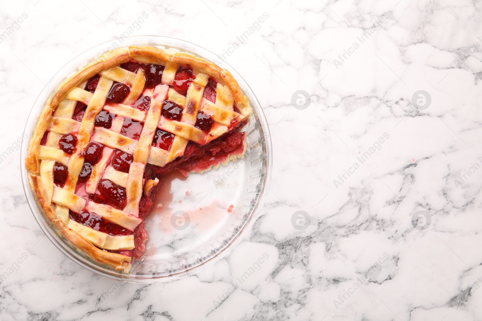 Tasty strawberry pie in baking dish on white marble table, top view. Space for text Photo of Tasty strawberry pie in baking dish on white marble table, top view. Space for text