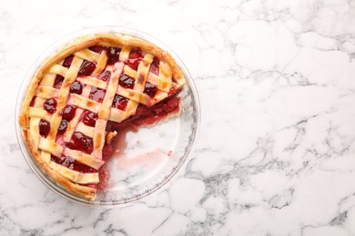 Photo of Tasty strawberry pie in baking dish on white marble table, top view. Space for text
