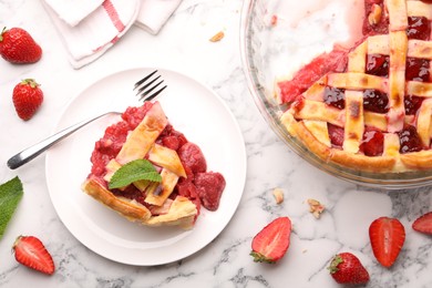 Photo of Tasty strawberry pie and berries on white marble table, flat lay