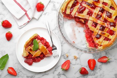 Photo of Tasty strawberry pie and berries on white marble table, flat lay