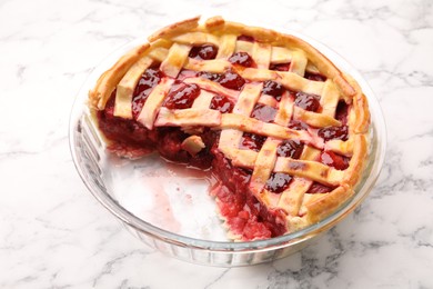 Photo of Tasty strawberry pie in baking dish on white marble table, closeup