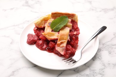 Photo of Piece of tasty strawberry pie on white marble table, closeup