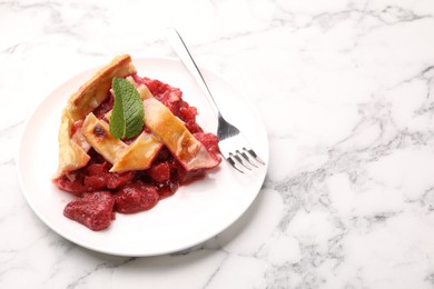 Photo of Piece of tasty strawberry pie on white marble table, closeup. Space for text