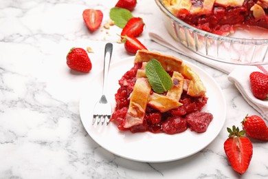Photo of Piece of tasty strawberry pie and berries on white marble table, closeup