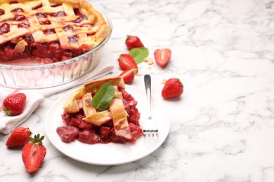 Photo of Piece of tasty strawberry pie and berries on white marble table. Space for text
