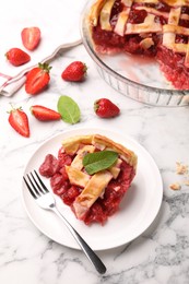 Photo of Piece of tasty strawberry pie and berries on white marble table, above view