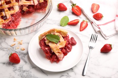Photo of Piece of tasty strawberry pie and berries on white marble table, closeup