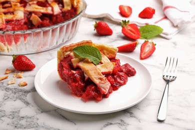 Photo of Piece of tasty strawberry pie and berries on white marble table, closeup