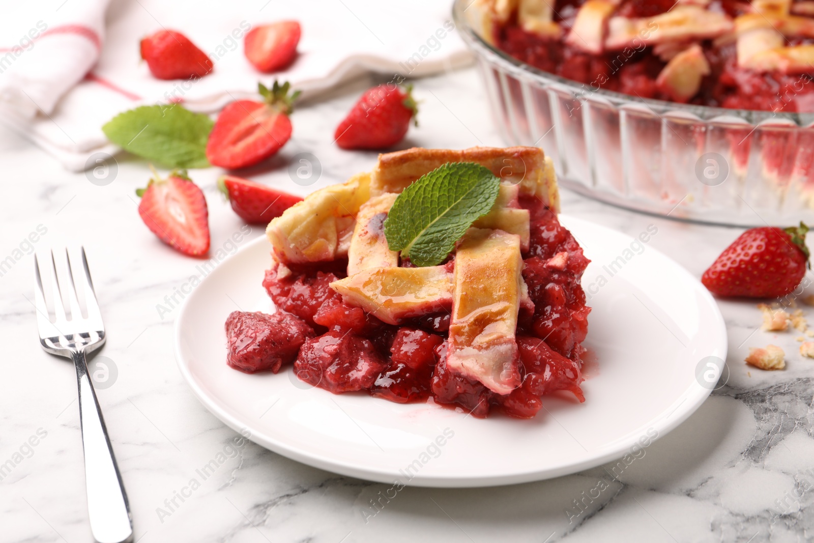 Piece of tasty strawberry pie and berries on white marble table, closeup Photo of Piece of tasty strawberry pie and berries on white marble table, closeup