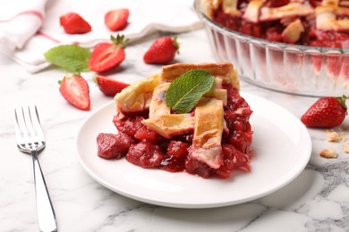 Photo of Piece of tasty strawberry pie and berries on white marble table, closeup