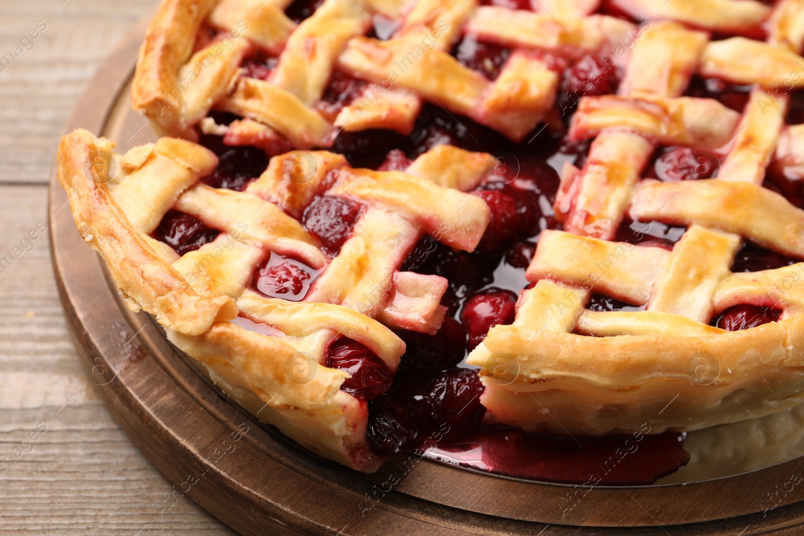 Tasty cut cherry pie on wooden table, closeup Photo of Tasty cut cherry pie on wooden table, closeup