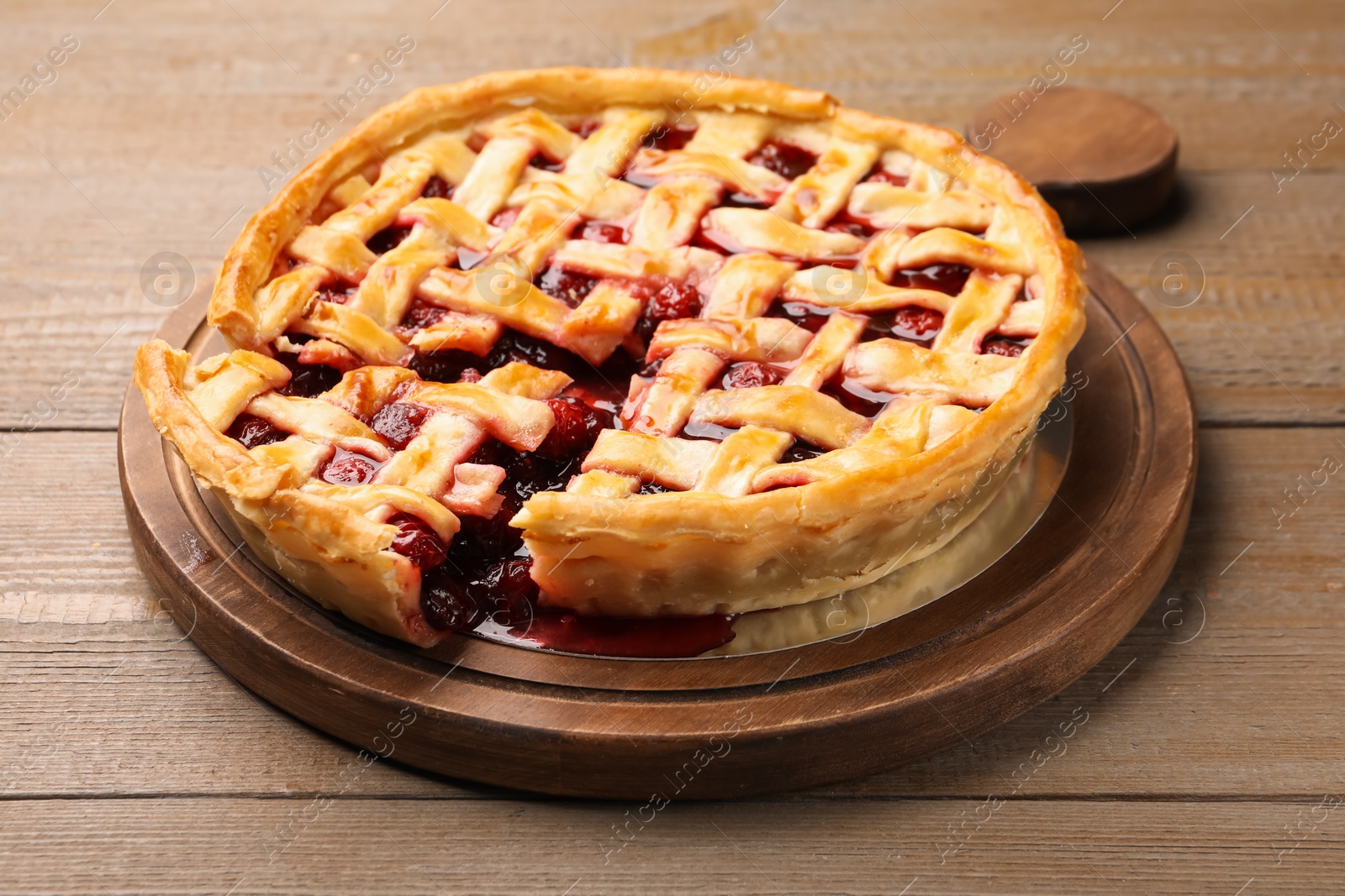 Tasty cut cherry pie on wooden table, closeup Photo of Tasty cut cherry pie on wooden table, closeup