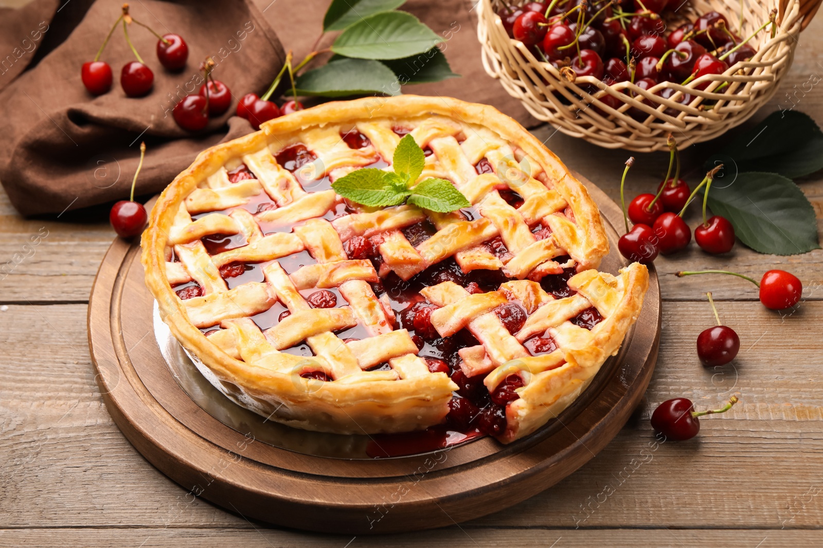 Tasty cut cherry pie and berries on wooden table, closeup Photo of Tasty cut cherry pie and berries on wooden table, closeup