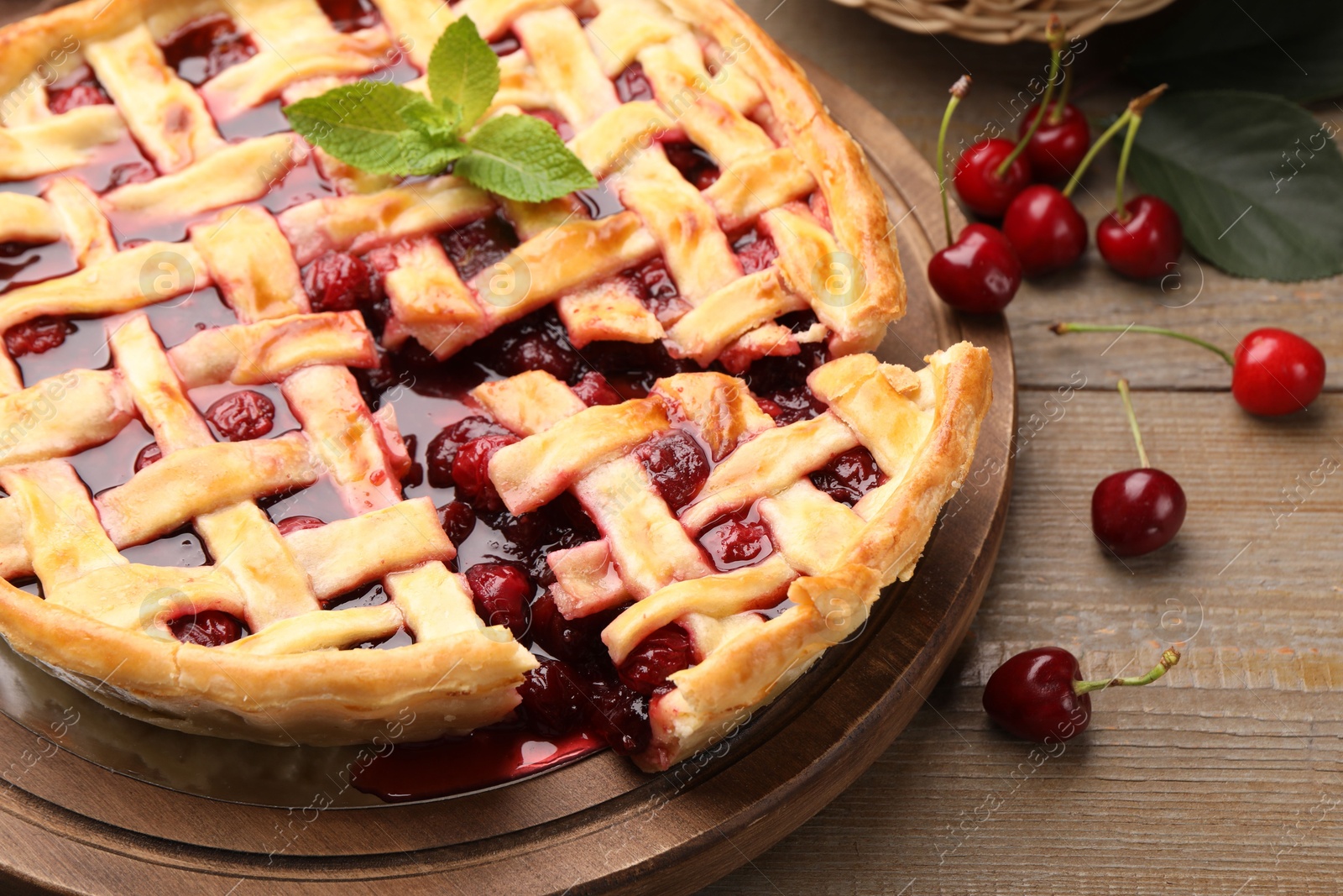 Tasty cut cherry pie and berries on wooden table, closeup Photo of Tasty cut cherry pie and berries on wooden table, closeup