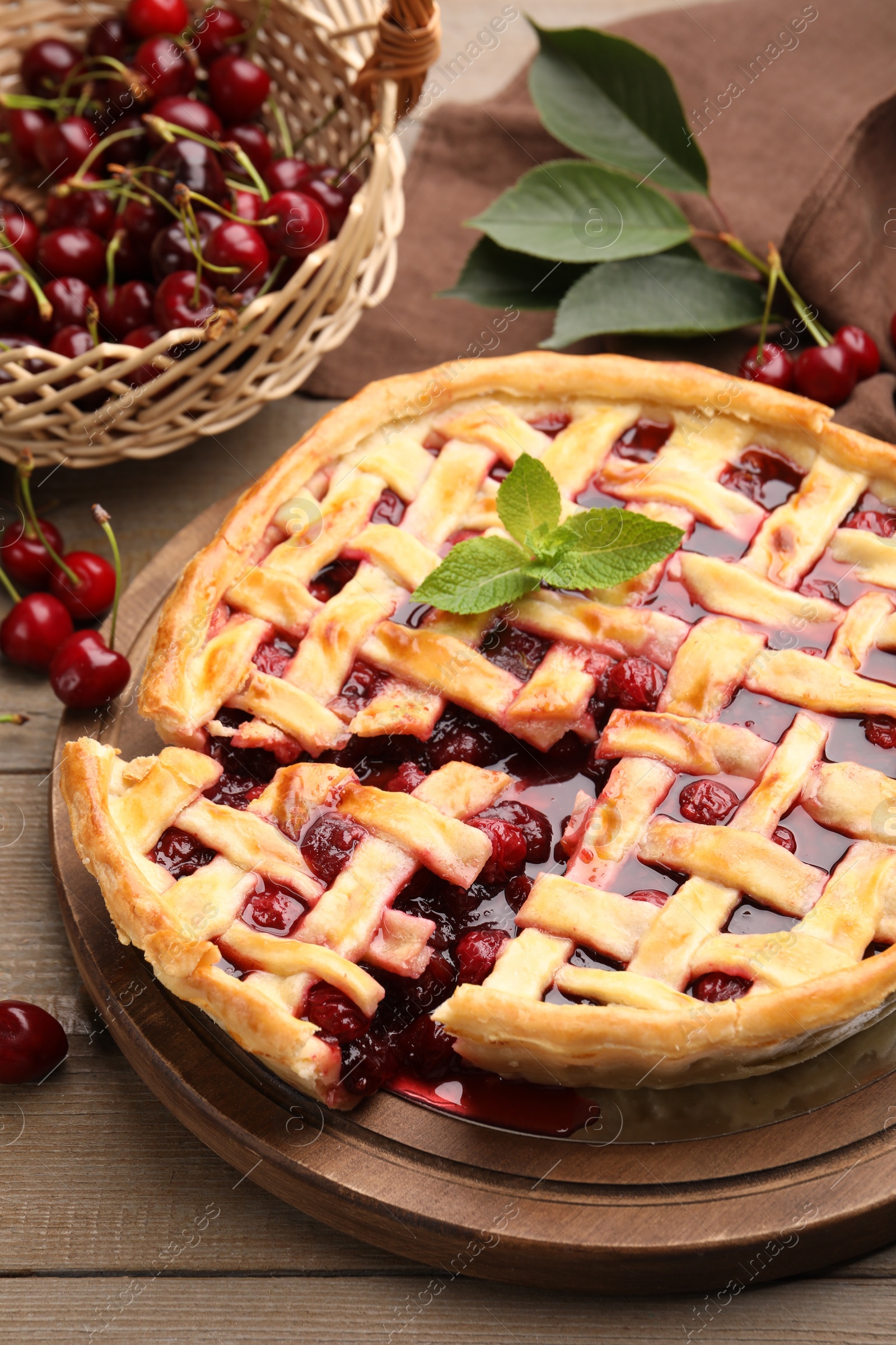 Tasty cut cherry pie and berries on wooden table, closeup Photo of Tasty cut cherry pie and berries on wooden table, closeup