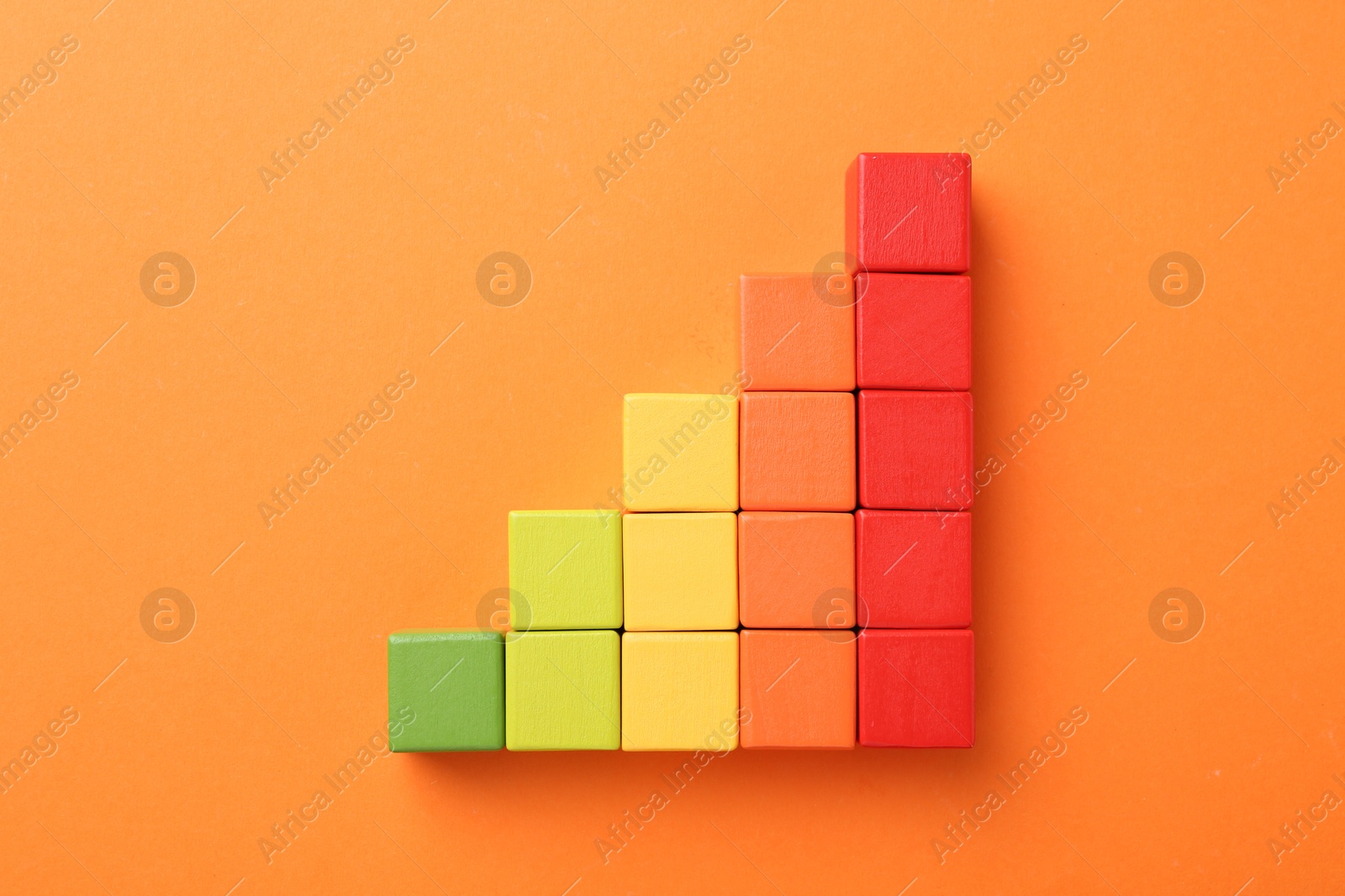 Maximum. Colorful cubes on orange background, top view Photo of Maximum. Colorful cubes on orange background, top view