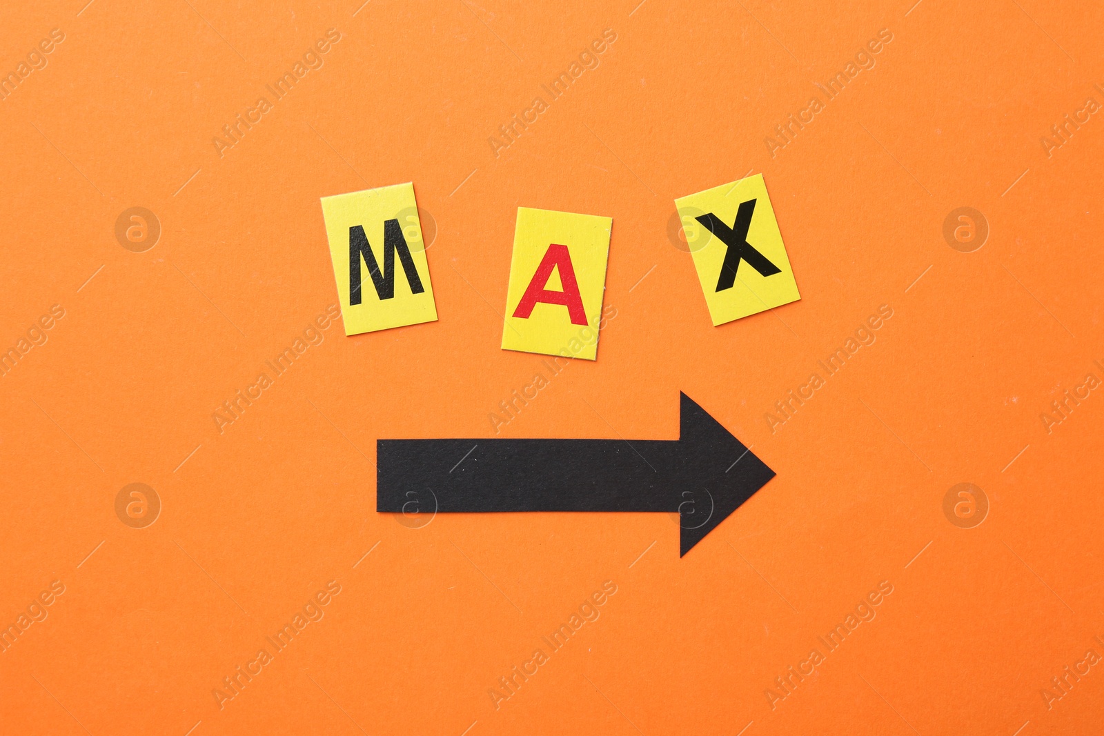 Word Maximum and arrow on orange background, top view Photo of Word Maximum and arrow on orange background, top view