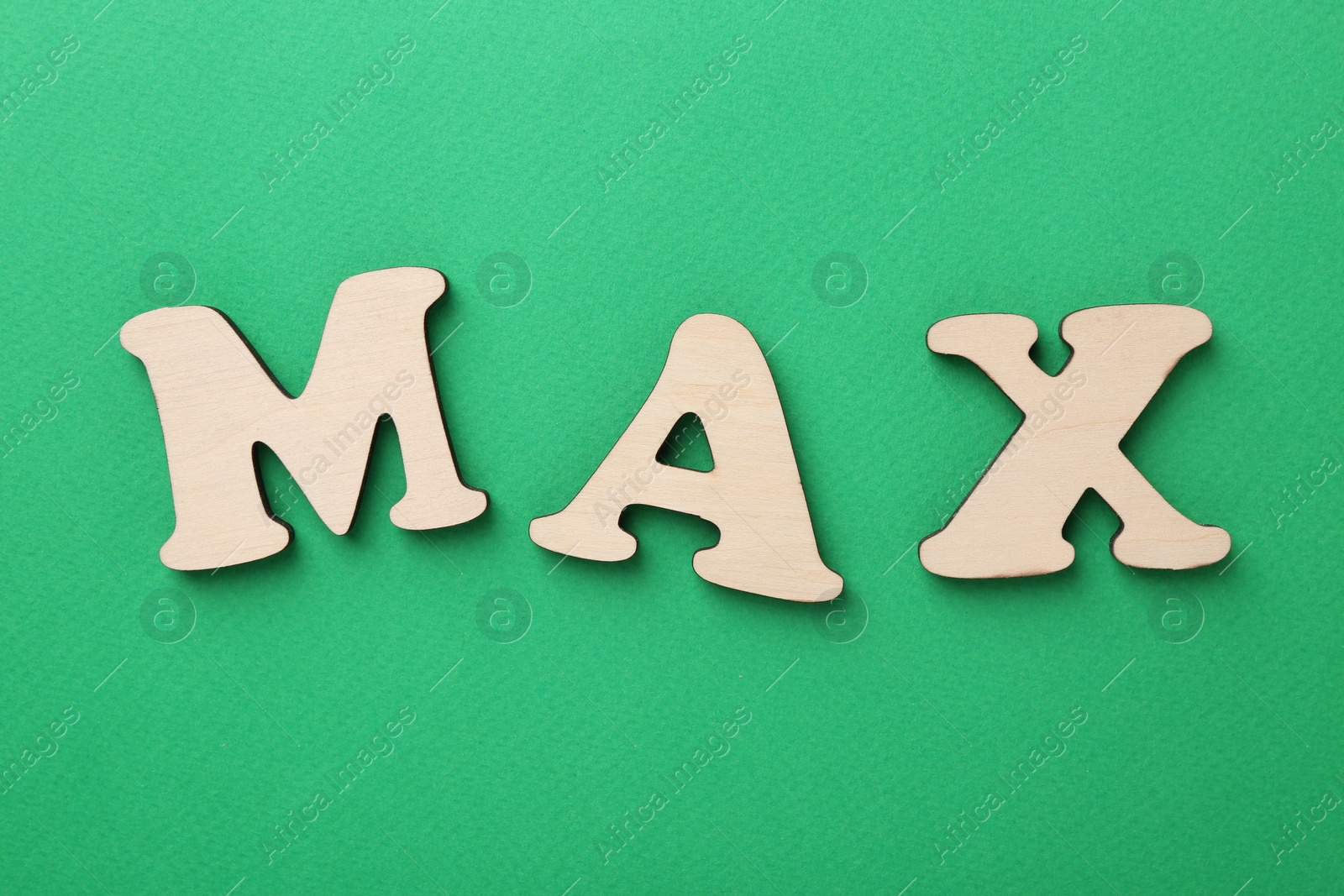 Word Max on green background, top view Photo of Word Max on green background, top view