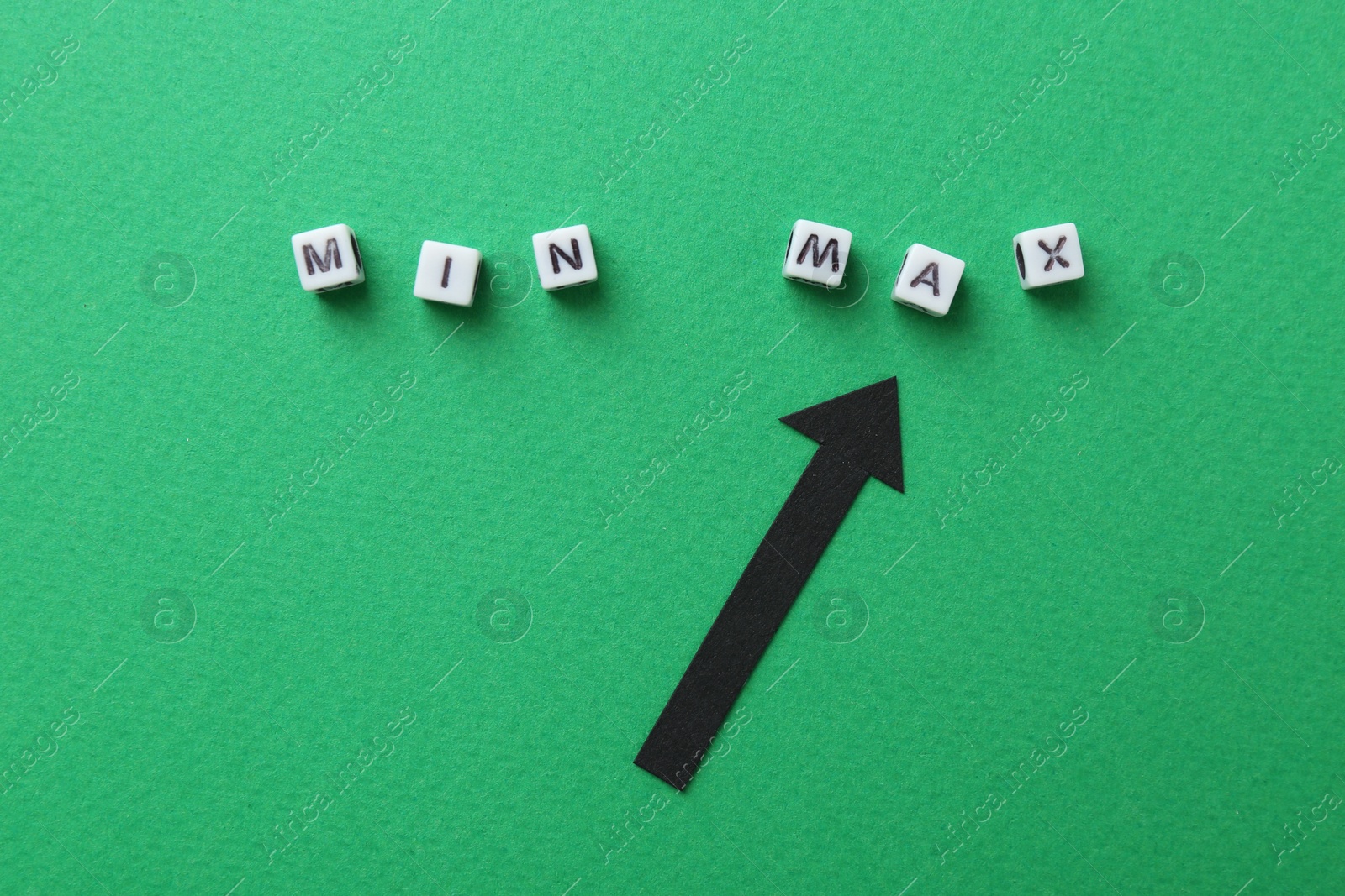 Words Min and Max made of cubes with arrow pointing at it on green background, flat lay Photo of Words Min and Max made of cubes with arrow pointing at it on green background, flat lay