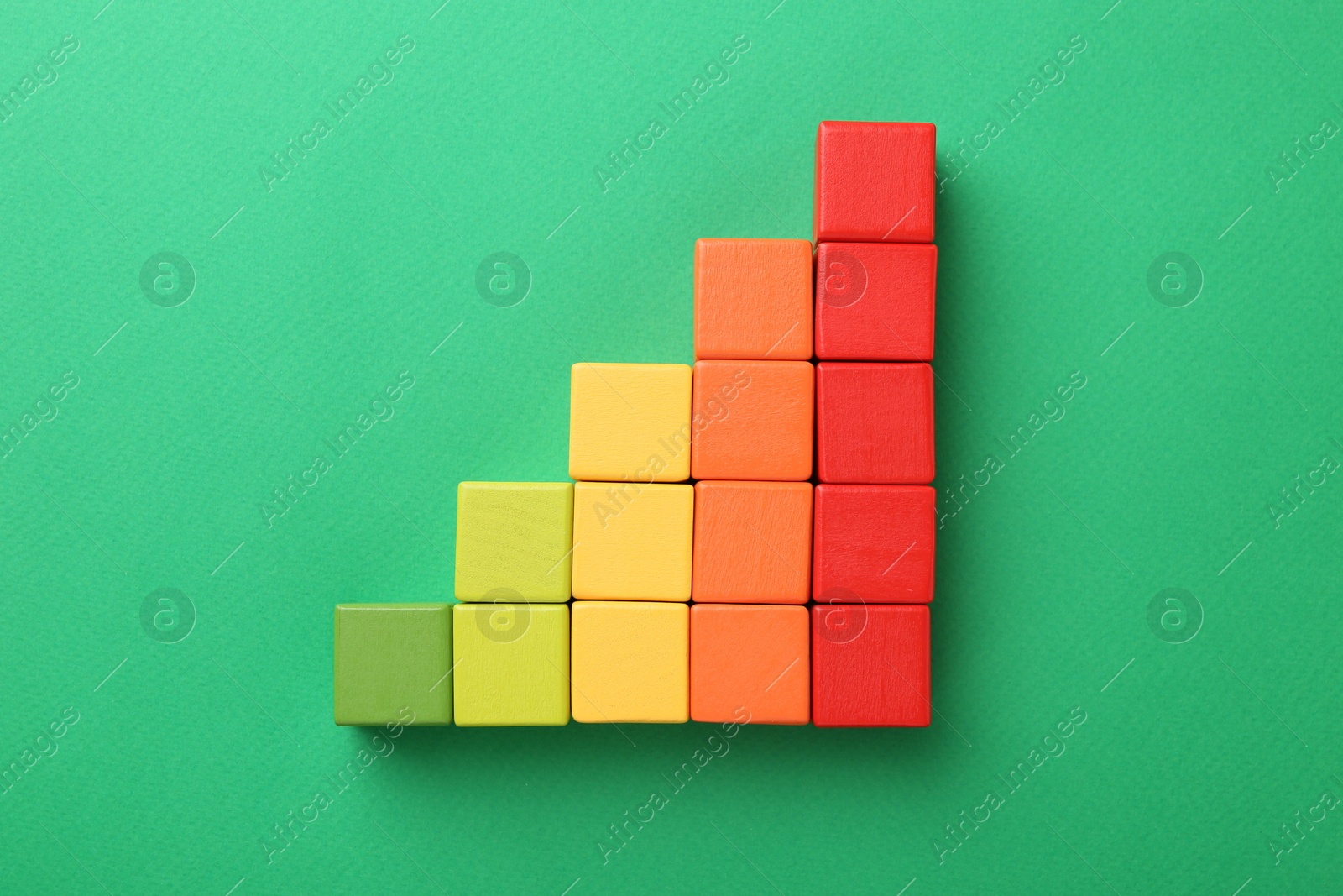 Maximum. Colorful cubes on green background, top view Photo of Maximum. Colorful cubes on green background, top view