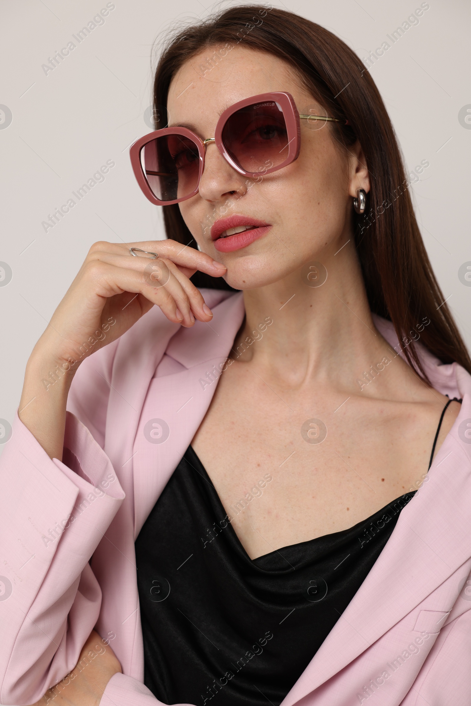 Portrait of beautiful woman in stylish outfit on white background Photo of Portrait of beautiful woman in stylish outfit on white background