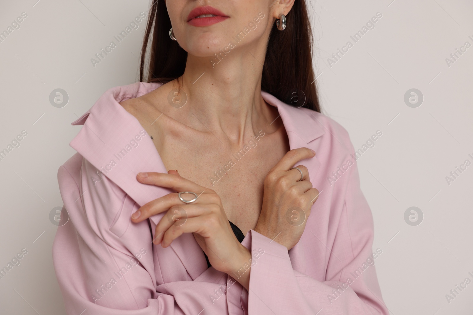 Woman in stylish outfit on white background, closeup Photo of Woman in stylish outfit on white background, closeup