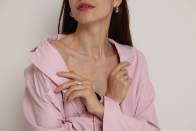 Photo of Woman in stylish outfit on white background, closeup
