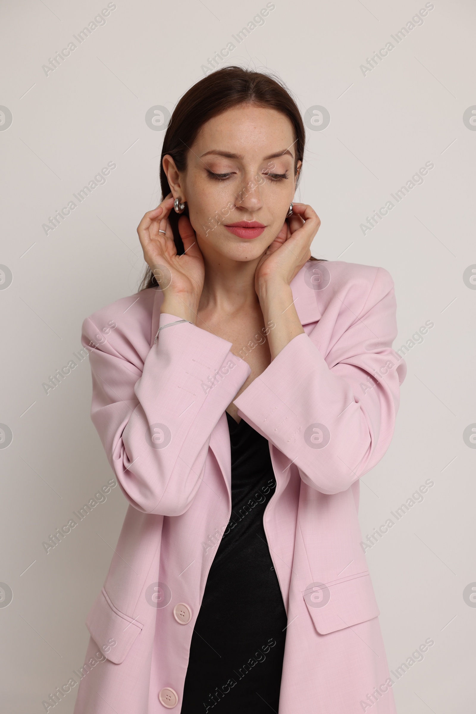 Portrait of beautiful woman in stylish outfit on white background Photo of Portrait of beautiful woman in stylish outfit on white background