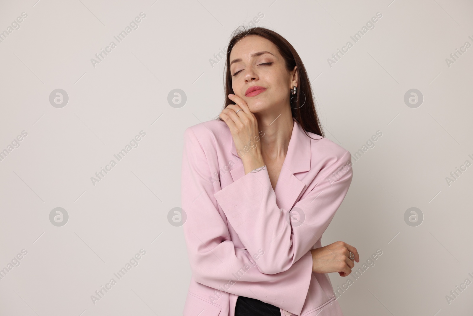 Portrait of beautiful woman in stylish outfit on white background Photo of Portrait of beautiful woman in stylish outfit on white background