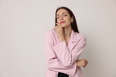 Photo of Portrait of beautiful woman in stylish outfit on white background