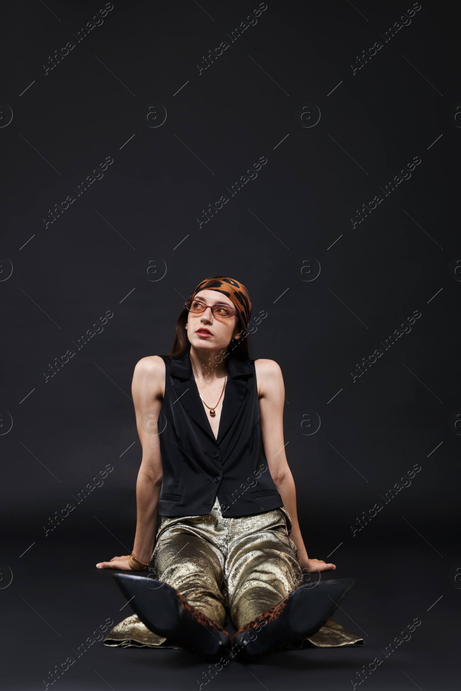 Full-length portrait of beautiful woman in stylish outfit on black background, space for text Photo of Full-length portrait of beautiful woman in stylish outfit on black background, space for text
