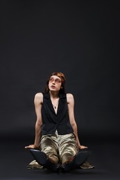 Photo of Full-length portrait of beautiful woman in stylish outfit on black background, space for text
