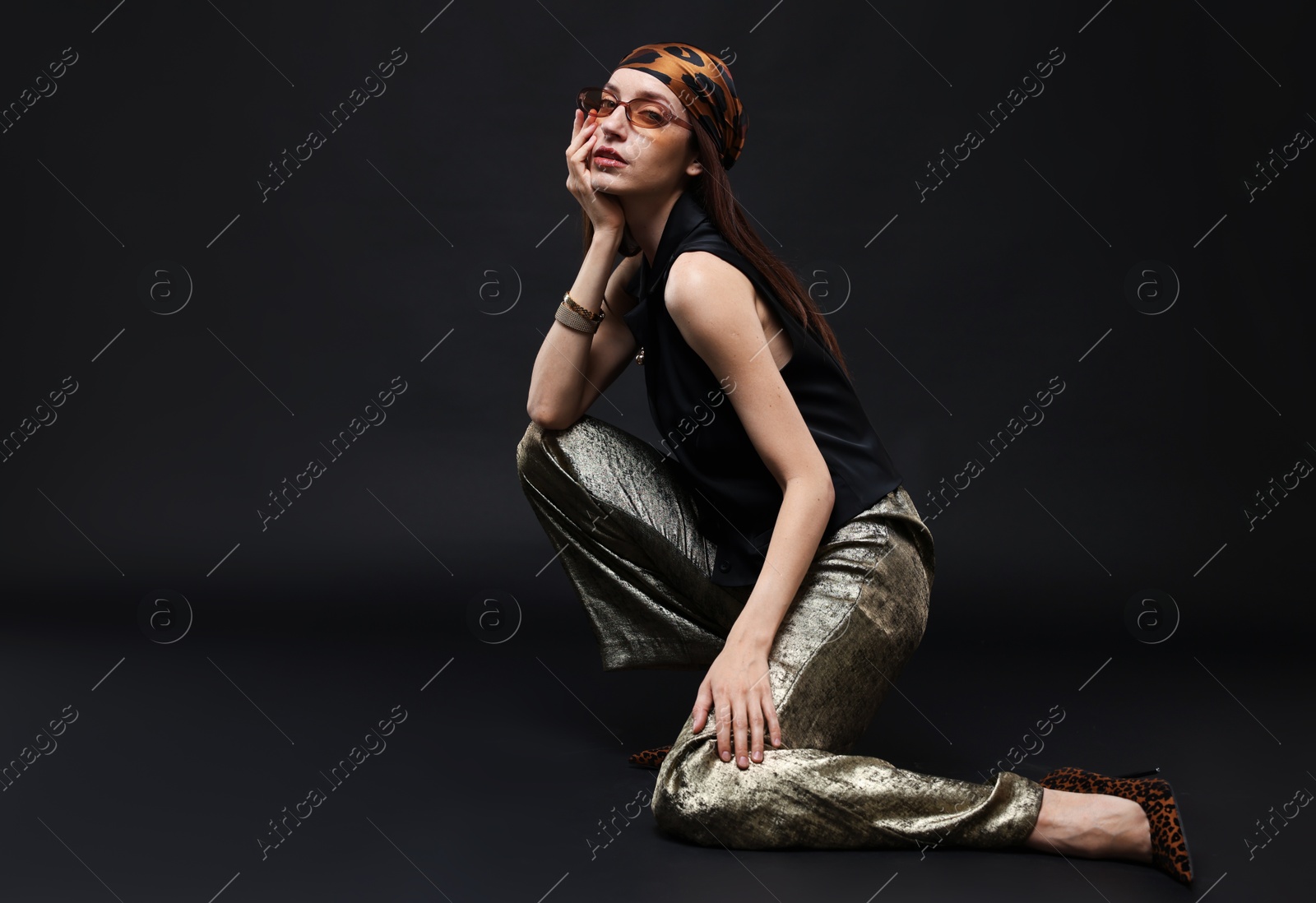 Full-length portrait of beautiful woman in stylish outfit on black background Photo of Full-length portrait of beautiful woman in stylish outfit on black background