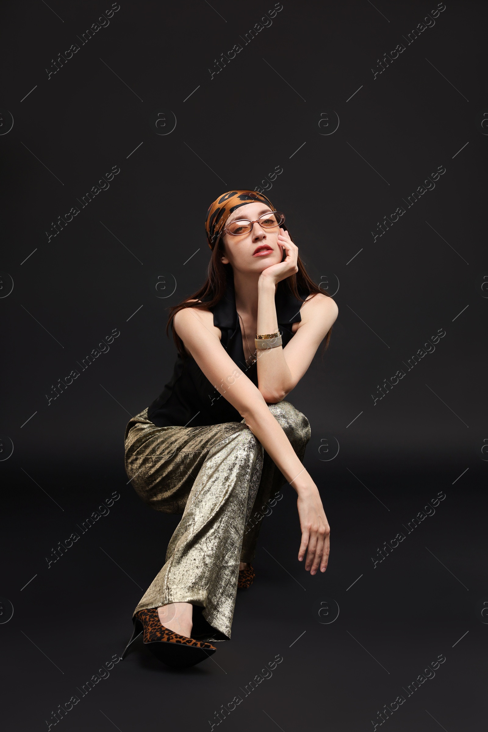 Full-length portrait of beautiful woman in stylish outfit on black background Photo of Full-length portrait of beautiful woman in stylish outfit on black background