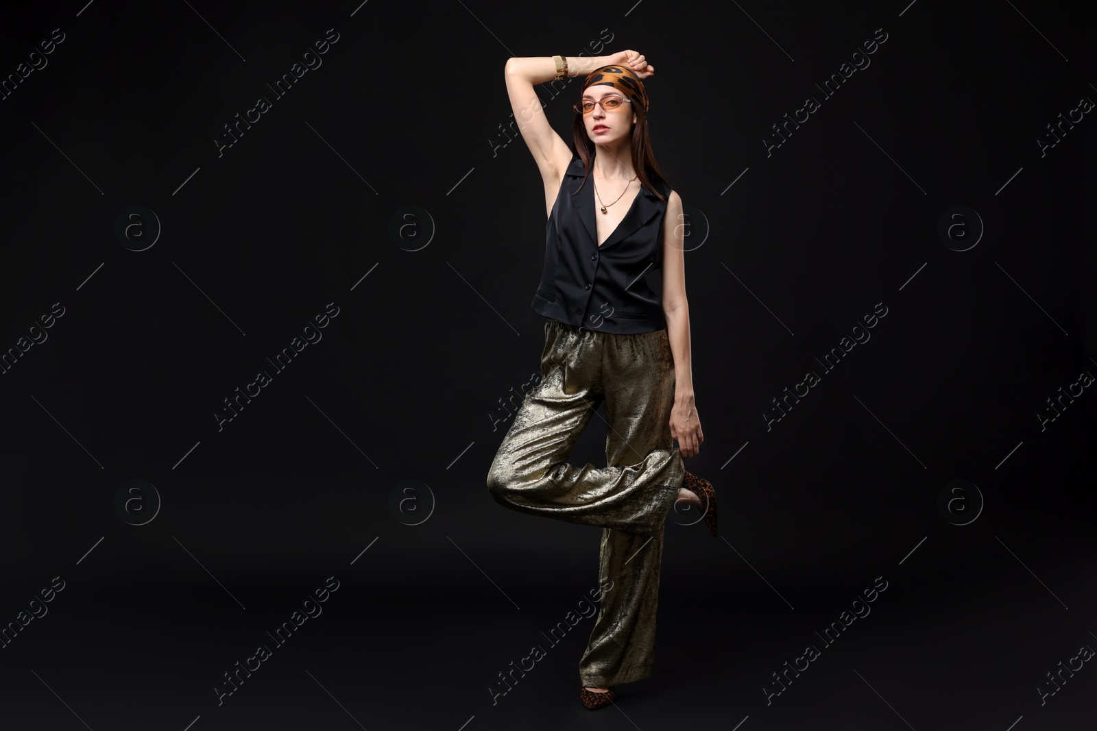 Full-length portrait of beautiful woman in stylish outfit on black background Photo of Full-length portrait of beautiful woman in stylish outfit on black background