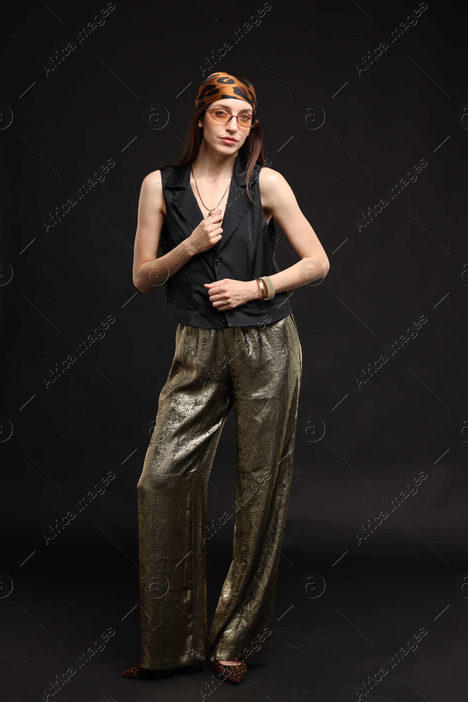 Full-length portrait of beautiful woman in stylish outfit on black background Photo of Full-length portrait of beautiful woman in stylish outfit on black background