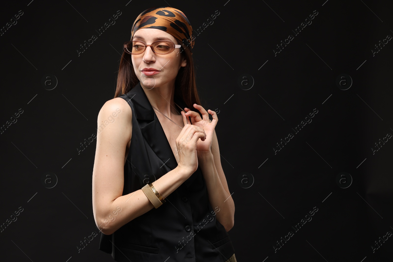 Portrait of beautiful woman in stylish outfit on black background, space for text Photo of Portrait of beautiful woman in stylish outfit on black background, space for text