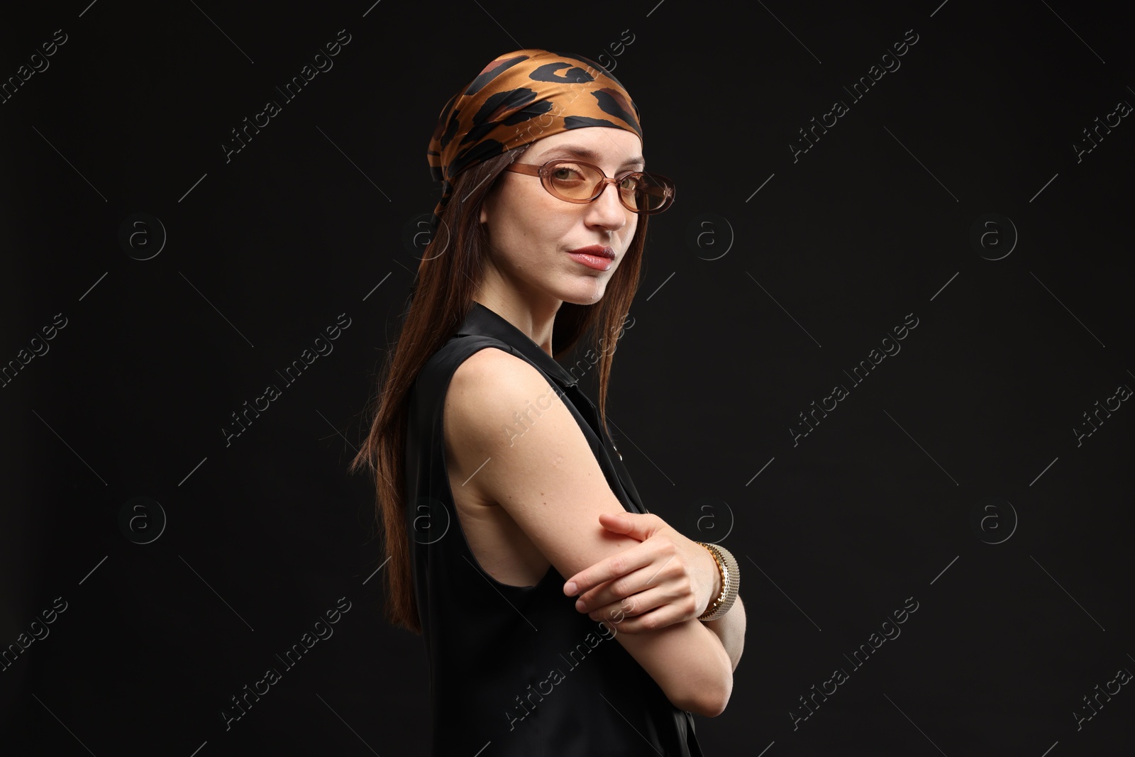 Portrait of beautiful woman in stylish outfit on black background Photo of Portrait of beautiful woman in stylish outfit on black background
