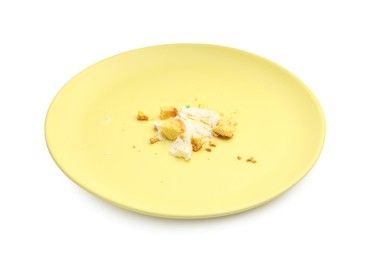 Photo of Dirty plate with crumbs and cream isolated on white