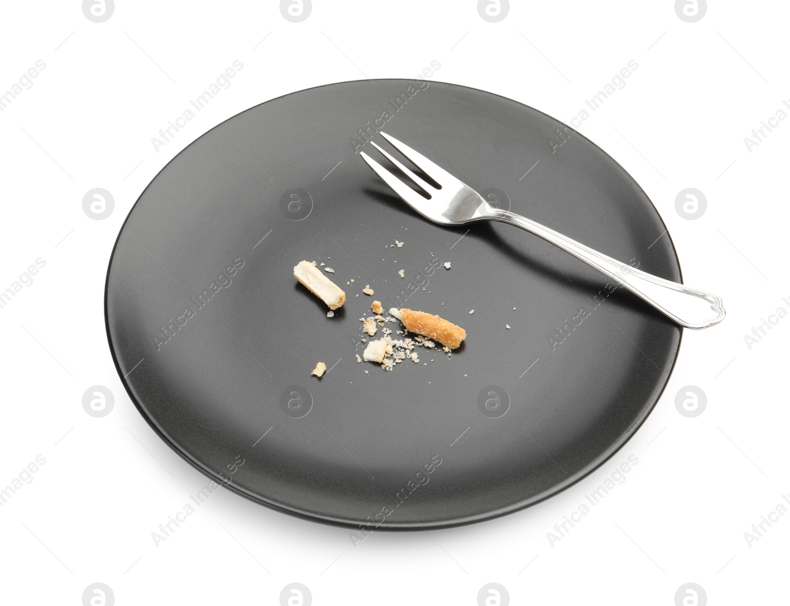 Dirty plate with bread crumbs and fork isolated on white Photo of Dirty plate with bread crumbs and fork isolated on white