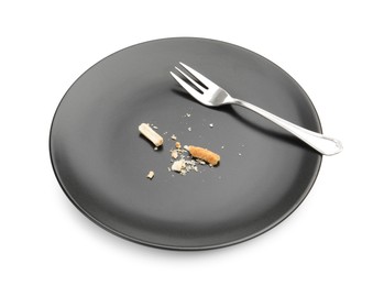 Photo of Dirty plate with bread crumbs and fork isolated on white