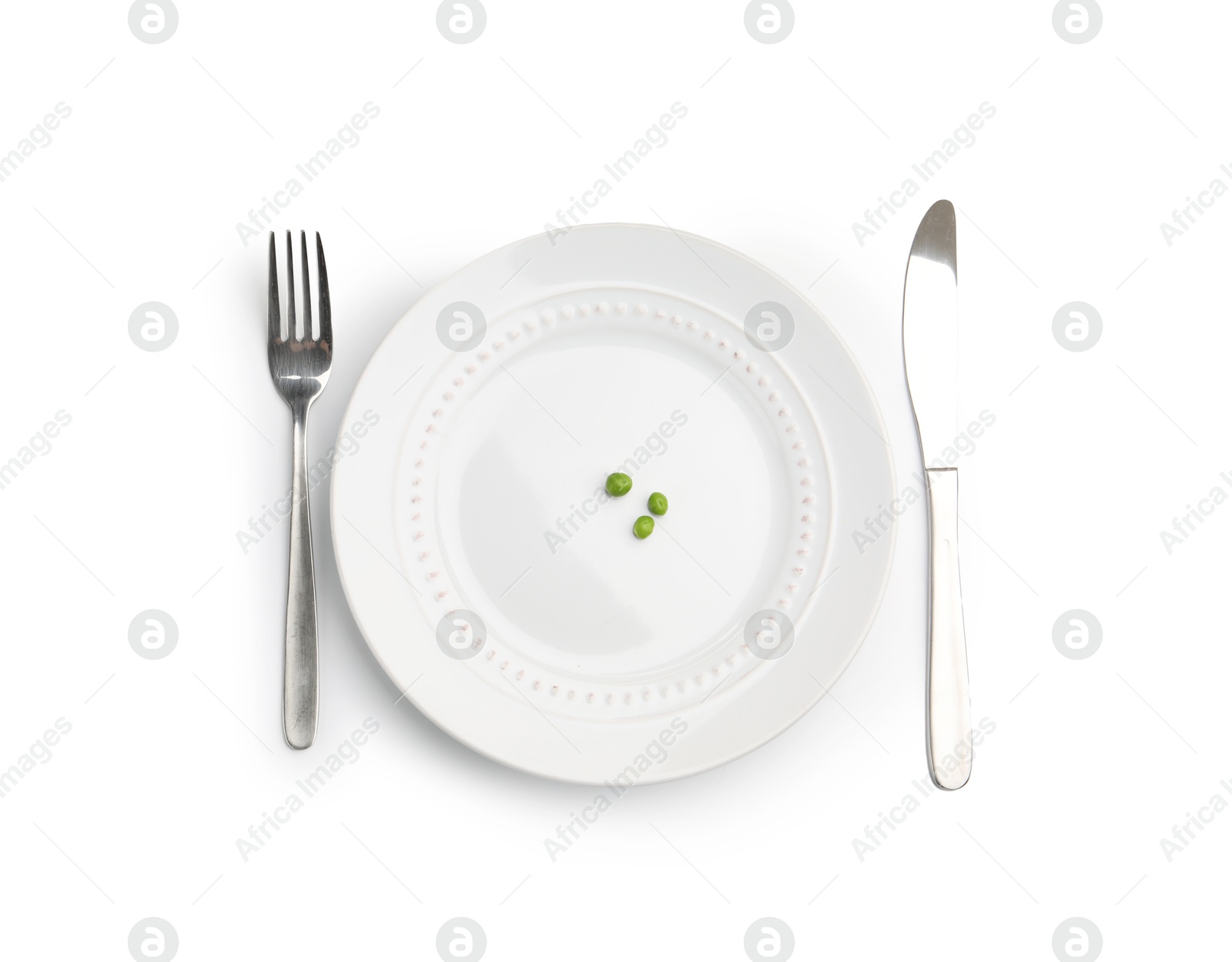 Plate with fresh green peas and cutlery isolated on white, top view Photo of Plate with fresh green peas and cutlery isolated on white, top view