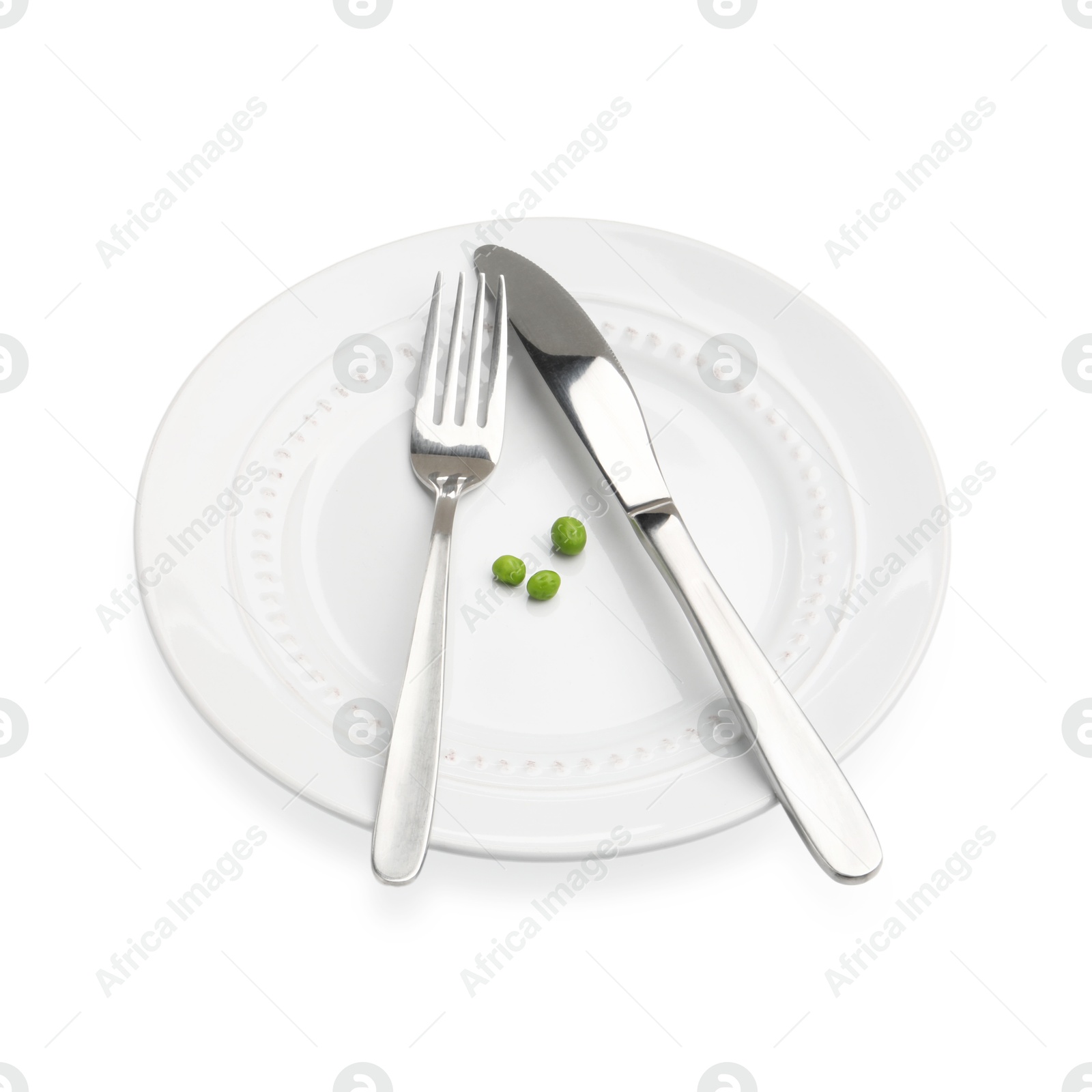 Plate with fresh green peas and cutlery isolated on white Photo of Plate with fresh green peas and cutlery isolated on white